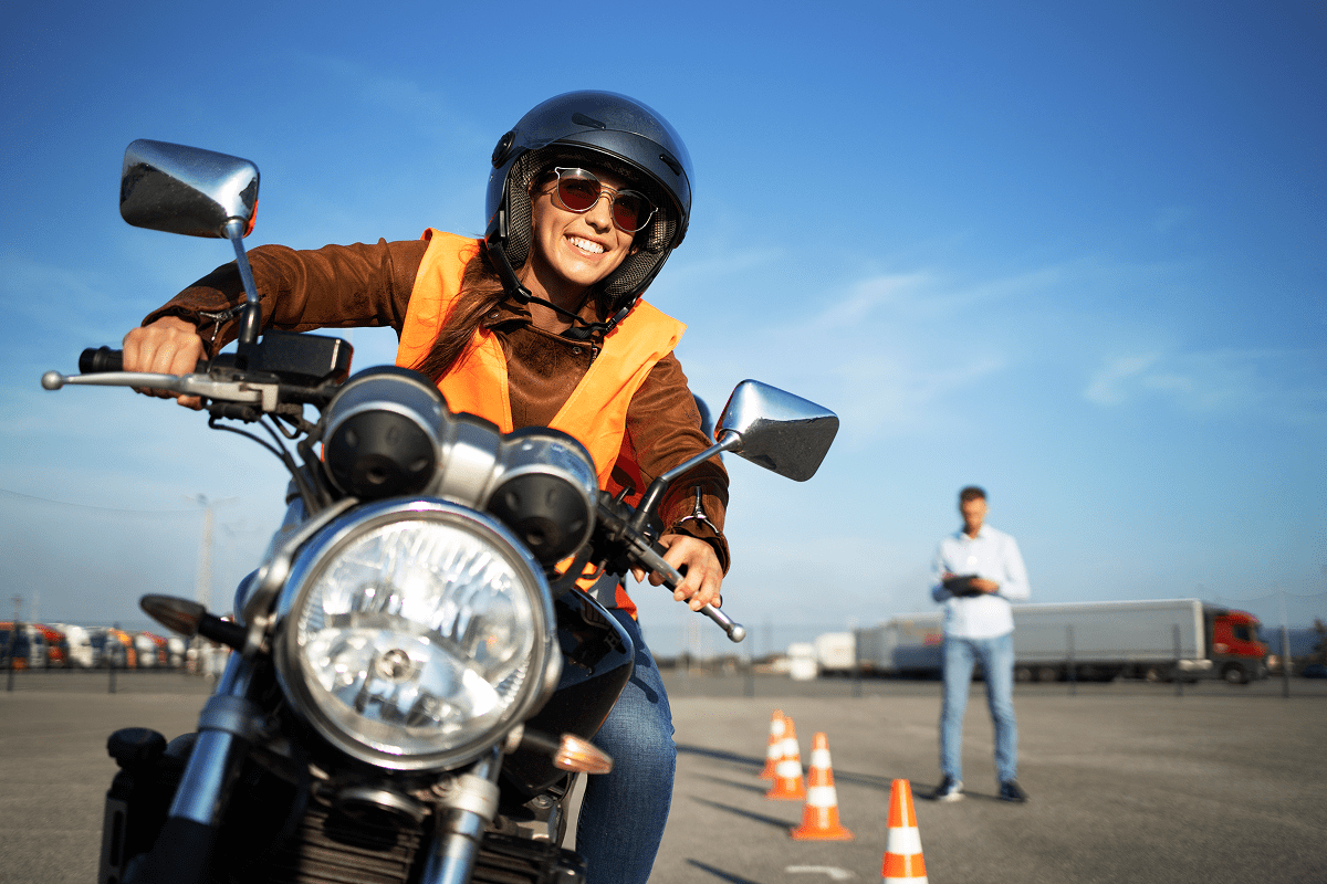 Person riding motorcycle during safety training course.