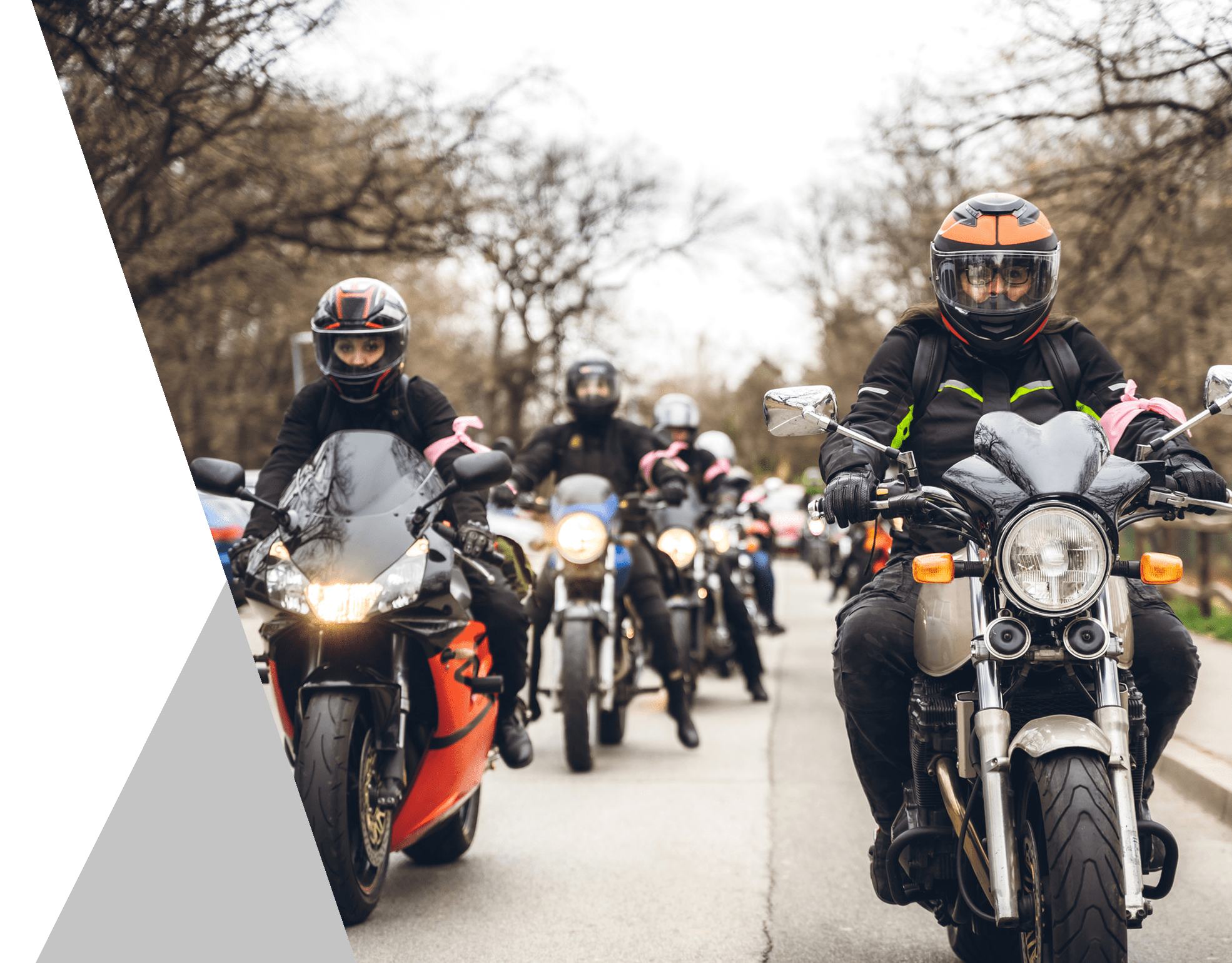 Group of motorcyclists riding on road.