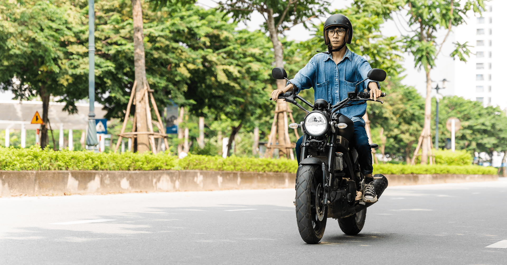 Man riding motorcycle on a city street.